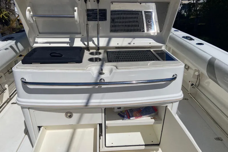 Slide: The Image of 2011 Boston Whaler 320 Outrage boat kitchen area with grill and storage compartments. - 10