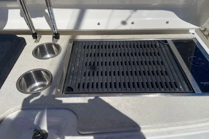 Slide: The Image of Boston Whaler 320 Outrage 2011 boat grill and sink setup on deck. - 11