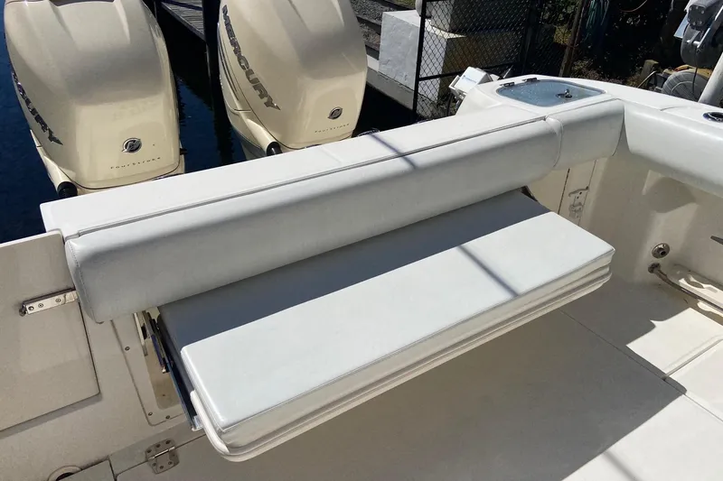 Slide: The Image of 2011 Boston Whaler 320 Outrage boat with foldable seating and twin Mercury engines. - 13