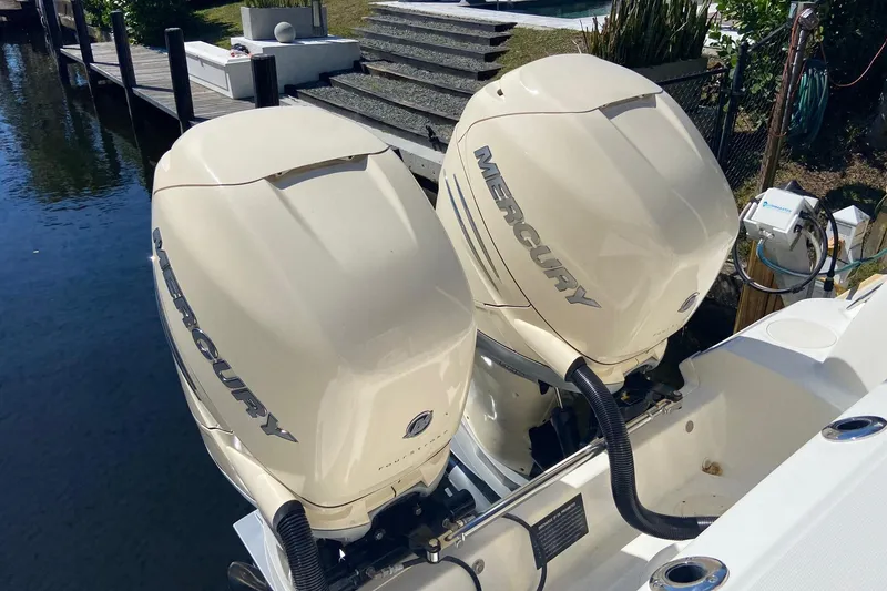 Slide: The Image of Twin Mercury outboard engines on a 2011 Boston Whaler 320 Outrage boat. - 14