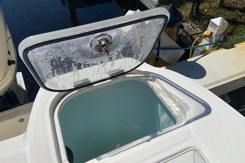 Slide: The Image of Open hatch on 2011 Boston Whaler 320 Outrage boat, revealing storage compartment. - 16