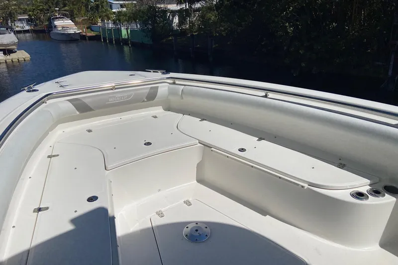 Slide: The Image of 2011 Boston Whaler 320 Outrage boat deck with seating and storage compartments. - 19