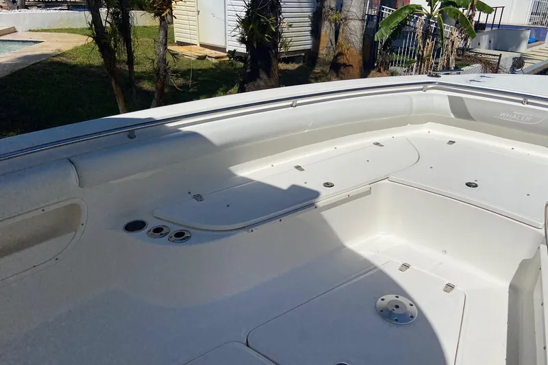 Slide: The Image of 2011 Boston Whaler 320 Outrage boat interior, featuring spacious seating and storage compartments. - 20