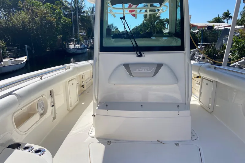 Slide: The Image of 2011 Boston Whaler 320 Outrage boat interior with seating and storage compartments. - 21