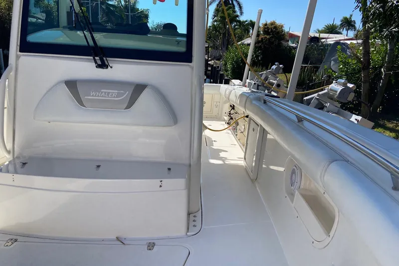 Slide: The Image of 2011 Boston Whaler 320 Outrage boat interior with seating and fishing equipment. - 23