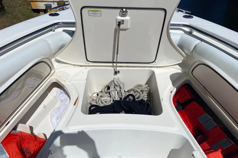 Slide: The Image of 2011 Boston Whaler 320 Outrage boat storage with ropes and life jackets. - 24
