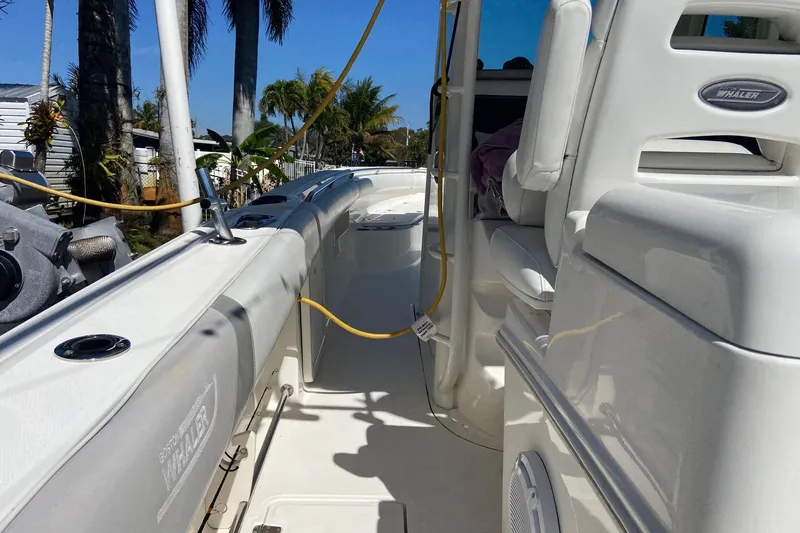 Slide: The Image of 2011 Boston Whaler 320 Outrage boat interior with seating and equipment, under sunny skies. - 27