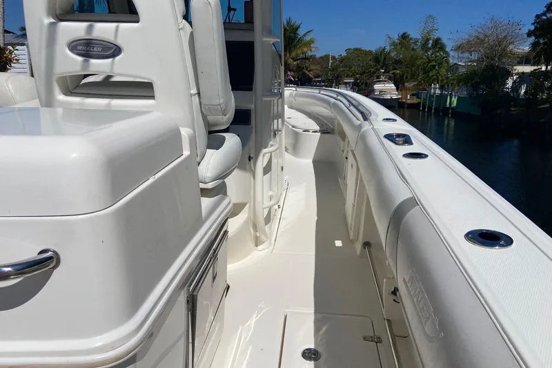 Slide: The Image of 2011 Boston Whaler 320 Outrage boat interior with white seating and sleek design. - 28