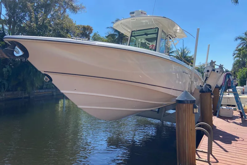 Slide: The Image of 2011 Boston Whaler 320 Outrage boat docked on a sunny day. - 34