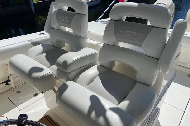 Slide: The Image of Luxury seating on a 2011 Boston Whaler 320 Outrage boat, featuring plush white upholstery. - 6