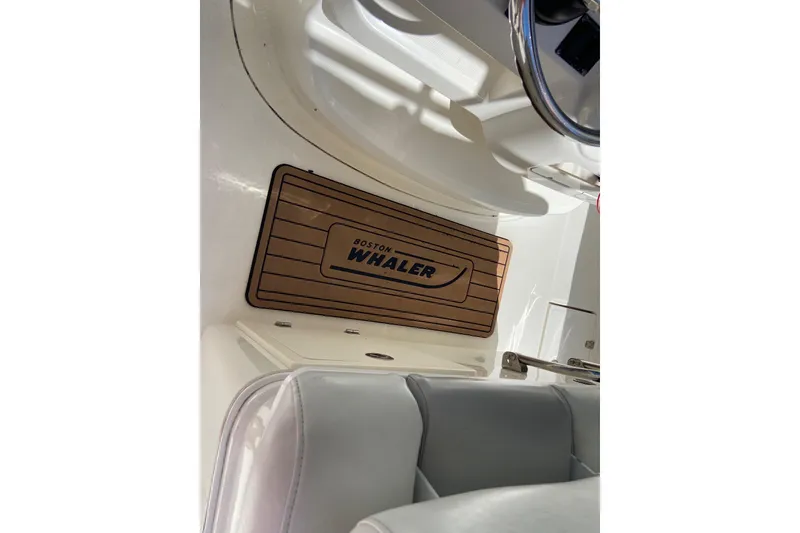 Slide: The Image of 2011 Boston Whaler 320 Outrage interior with branded floor mat and seating. - 7