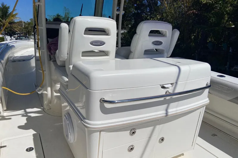 Slide: The Image of 2011 Boston Whaler 320 Outrage boat interior with seating and storage compartments. - 8