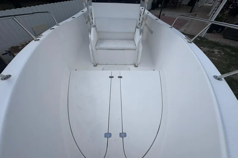 Slide: The Image of 2001 Cobia 254 Center Console boat interior with seating and storage compartments. - 12
