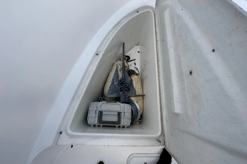 Slide: The Image of Storage compartment of a 2001 Cobia 254 Center Console boat with equipment inside. - 13