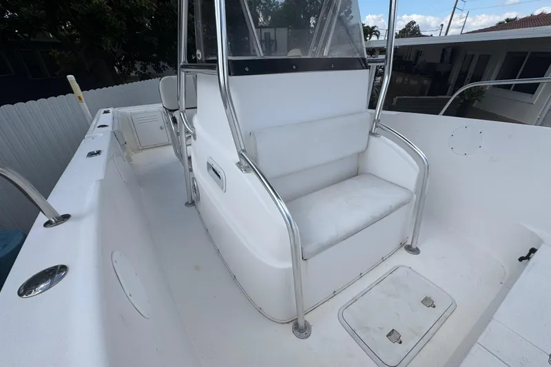Slide: The Image of 2001 Cobia 254 Center Console boat interior with seating and storage compartments. - 14