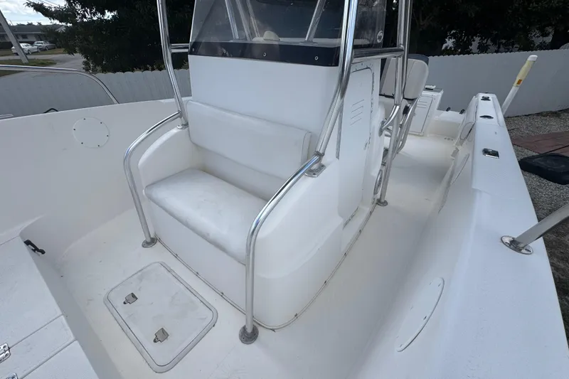 Slide: The Image of 2001 Cobia 254 Center Console boat interior with seating and storage compartments. - 15