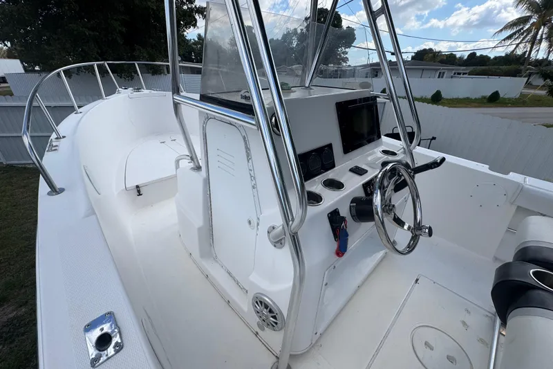Slide: The Image of 2001 Cobia 254 Center Console boat interior with steering wheel and control panel. - 17