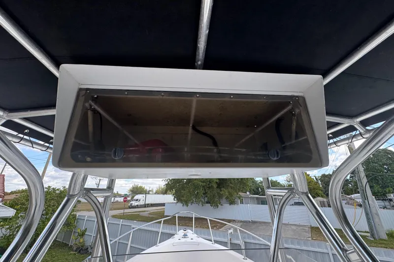 Slide: The Image of 2001 Cobia 254 Center Console boat with overhead storage compartment and metal framework. - 18
