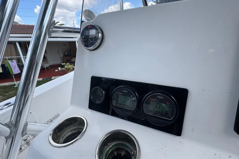 Slide: The Image of Console of 2001 Cobia 254 Center Console boat with gauges and controls. - 25