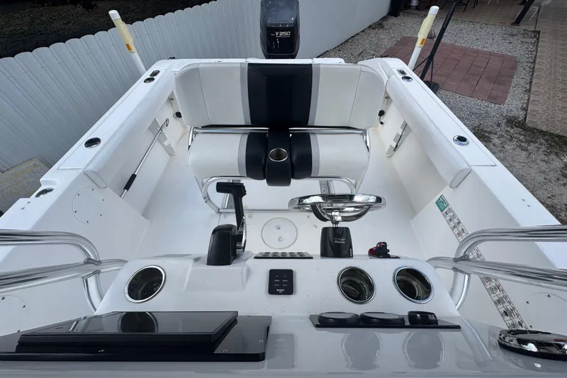 Slide: The Image of 2001 Cobia 254 Center Console boat interior with steering wheel and seating. - 28