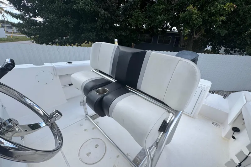 Slide: The Image of 2001 Cobia 254 Center Console boat interior with steering wheel and seating. - 32