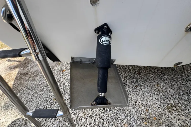 Slide: The Image of 2001 Cobia 254 Center Console boat with Lenco trim tab actuator. - 43