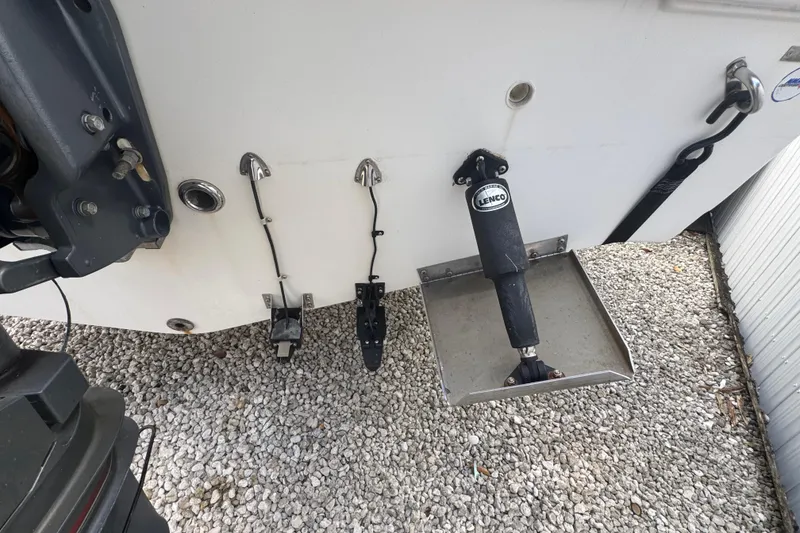 Slide: The Image of 2001 Cobia 254 Center Console boat transom with Lenco trim tab and hardware. - 44