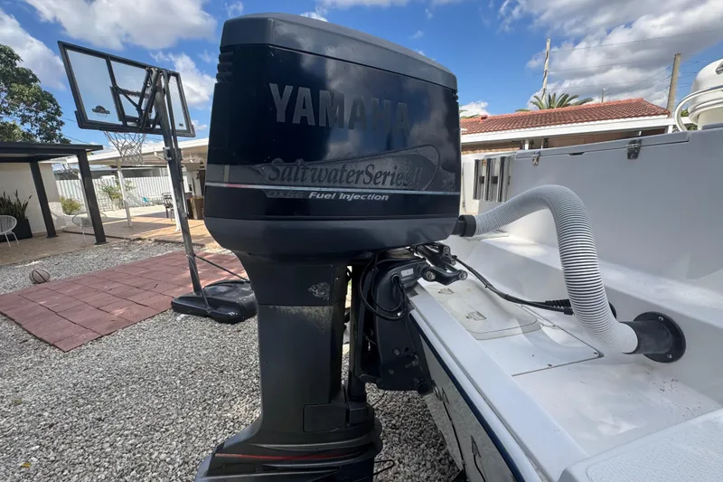 Slide: The Image of Yamaha outboard motor on 2001 Cobia 254 Center Console boat, outdoor setting. - 45