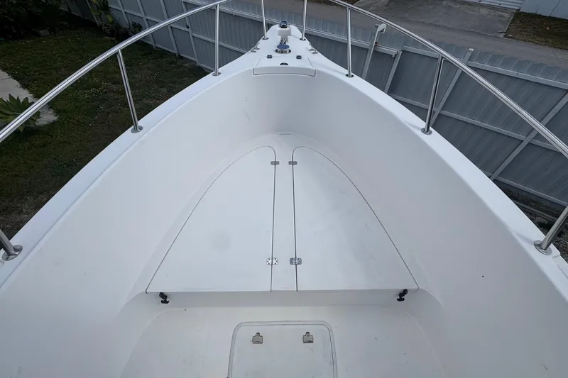 Slide: The Image of 2001 Cobia 254 Center Console boat deck with storage compartments. - 8
