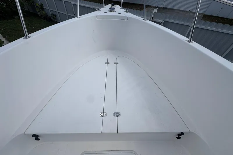 Slide: The Image of 2001 Cobia 254 Center Console boat deck with storage compartment, white finish. - 9