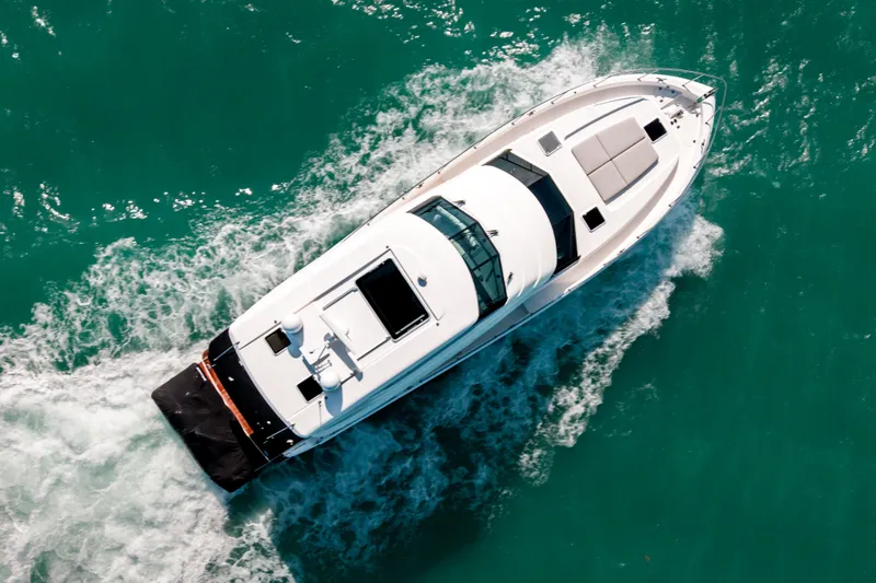 Slide: The Image of 2024 Maritimo M55 yacht cruising on turquoise water, aerial view. - 10