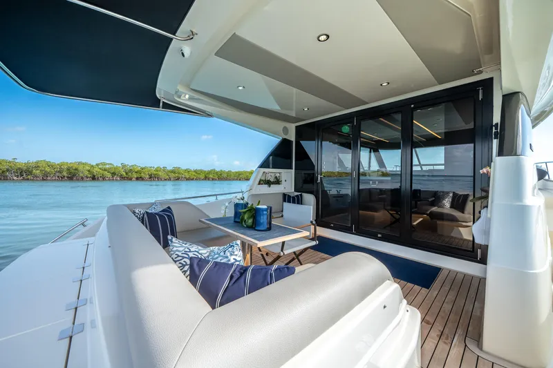Slide: The Image of 2024 Maritimo M55 yacht deck with luxurious seating and scenic water view. - 23