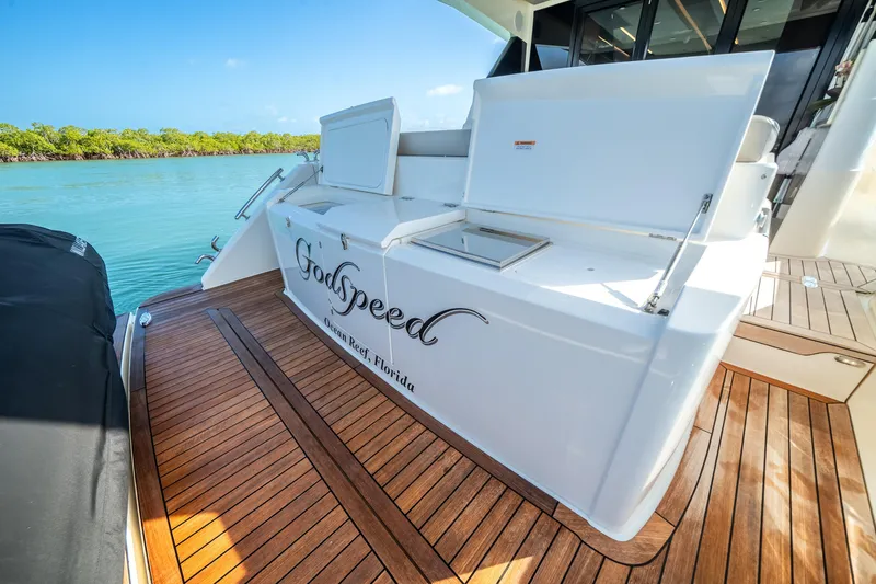 Slide: The Image of 2024 Maritimo M55 yacht deck with storage, labeled "GodSpeed," Ocean Reef, Florida. - 24