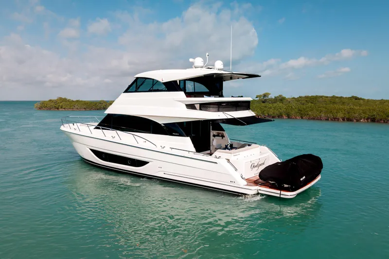 Slide: The Image of 2024 Maritimo M55 yacht cruising in clear blue waters under a sunny sky. - 3