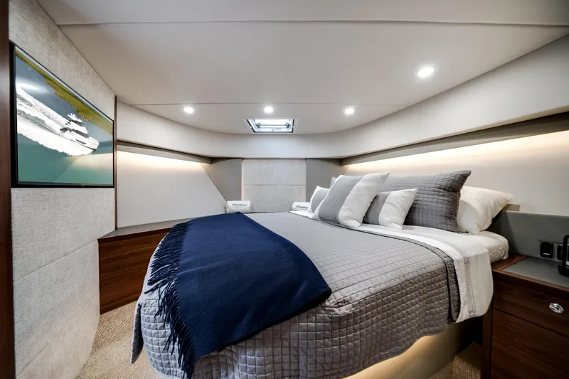 Slide: The Image of Luxurious 2024 Maritimo M55 yacht bedroom with modern decor and ambient lighting. - 35