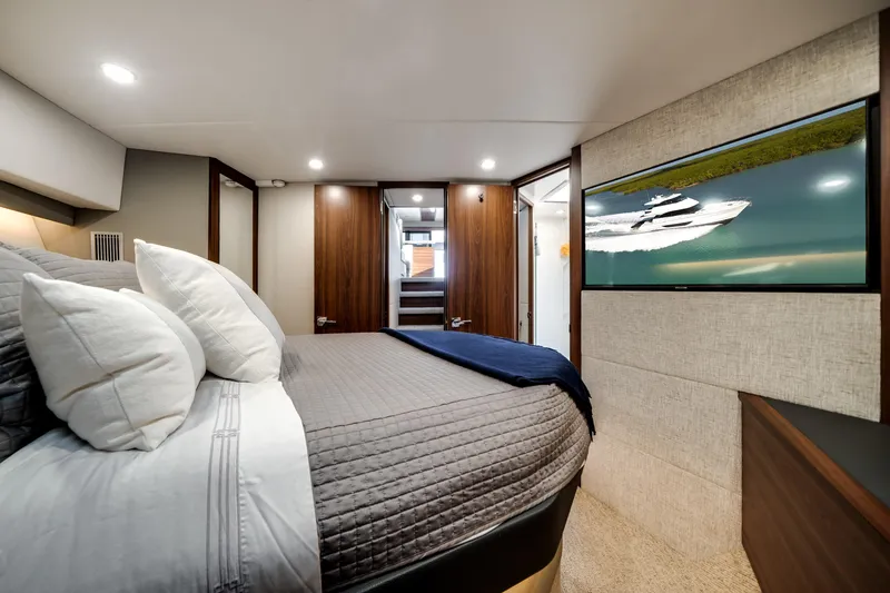 Slide: The Image of Luxurious 2024 Maritimo M55 yacht bedroom with modern decor and wall-mounted TV. - 36