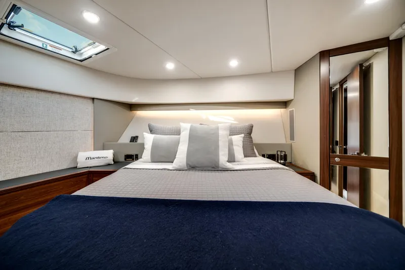 Slide: The Image of Luxurious 2024 Maritimo M55 yacht bedroom with modern design and elegant bedding. - 37