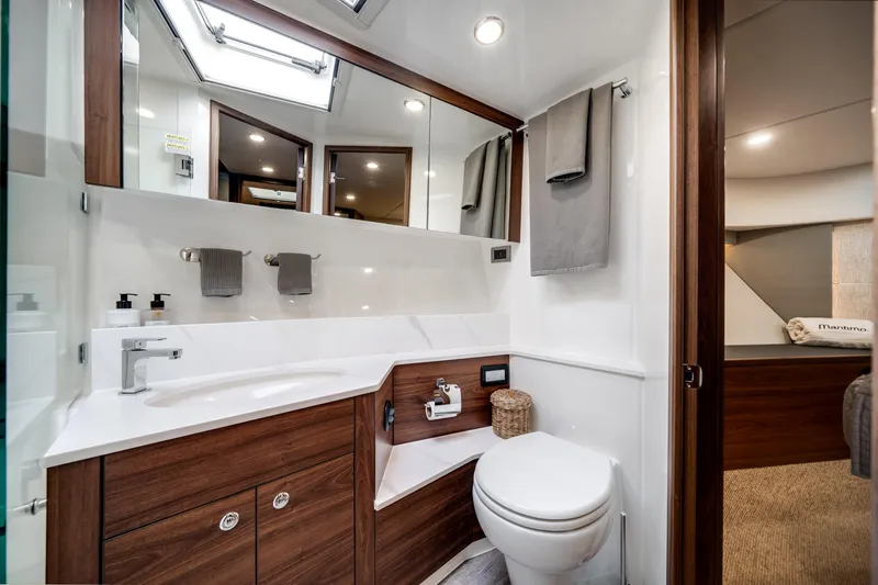 Slide: The Image of Luxurious bathroom in 2024 Maritimo M55 yacht with modern fixtures and elegant wood accents. - 39