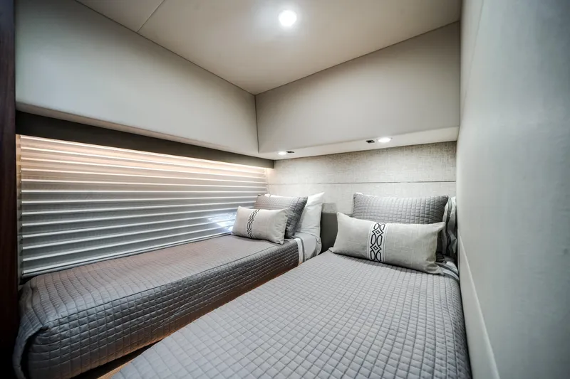 Slide: The Image of 2024 Maritimo M55 yacht interior with twin beds, modern design, and ambient lighting. - 40