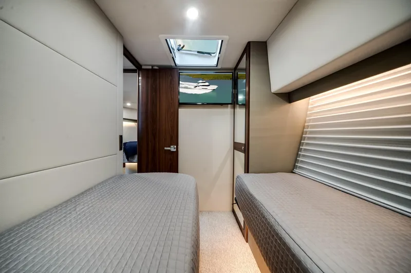 Slide: The Image of 2024 Maritimo M55 yacht interior cabin with twin beds and modern design. - 41