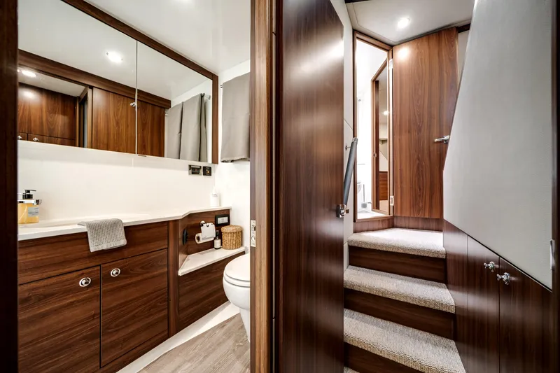 Slide: The Image of Luxurious bathroom interior of 2024 Maritimo M55 yacht with wooden cabinetry and modern fixtures. - 48