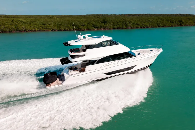 Slide: The Image of 2024 Maritimo M55 yacht cruising on turquoise water, showcasing sleek design and luxury. - 8