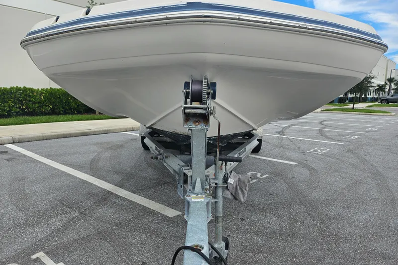 Slide: The Image of 2006 Hurricane SunDeck 237 OB boat on trailer in parking lot. - 10