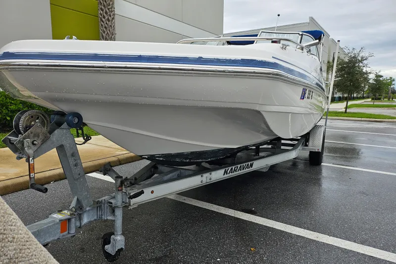 Slide: The Image of 2006 Hurricane SunDeck 237 OB boat on trailer in parking lot. - 11