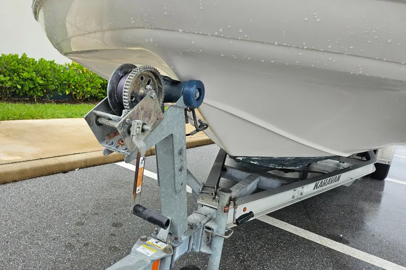 Slide: The Image of 2006 Hurricane SunDeck 237 OB boat on trailer, close-up of winch and hull. - 12