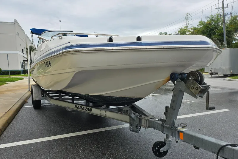 Slide: The Image of 2006 Hurricane SunDeck 237 OB boat on trailer in parking lot. - 21