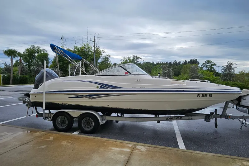 Slide: The Image of 2006 Hurricane SunDeck 237 OB boat on trailer in parking lot. - 22