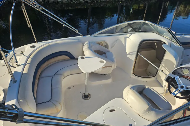 Slide: The Image of 2006 Hurricane SunDeck 237 OB boat interior with seating and steering wheel. - 27