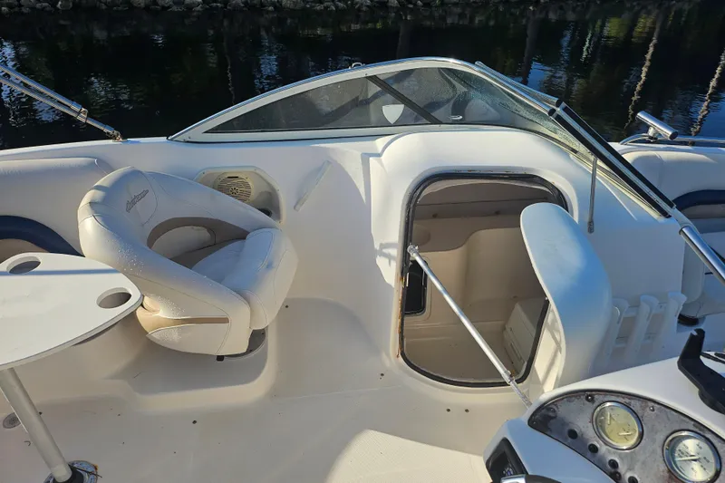 Slide: The Image of 2006 Hurricane SunDeck 237 OB boat interior with seating and cabin entrance. - 29