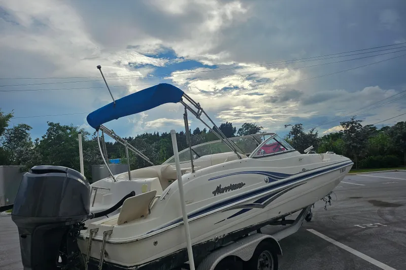 Slide: The Image of 2006 Hurricane SunDeck 237 OB boat on trailer under cloudy sky. - 3